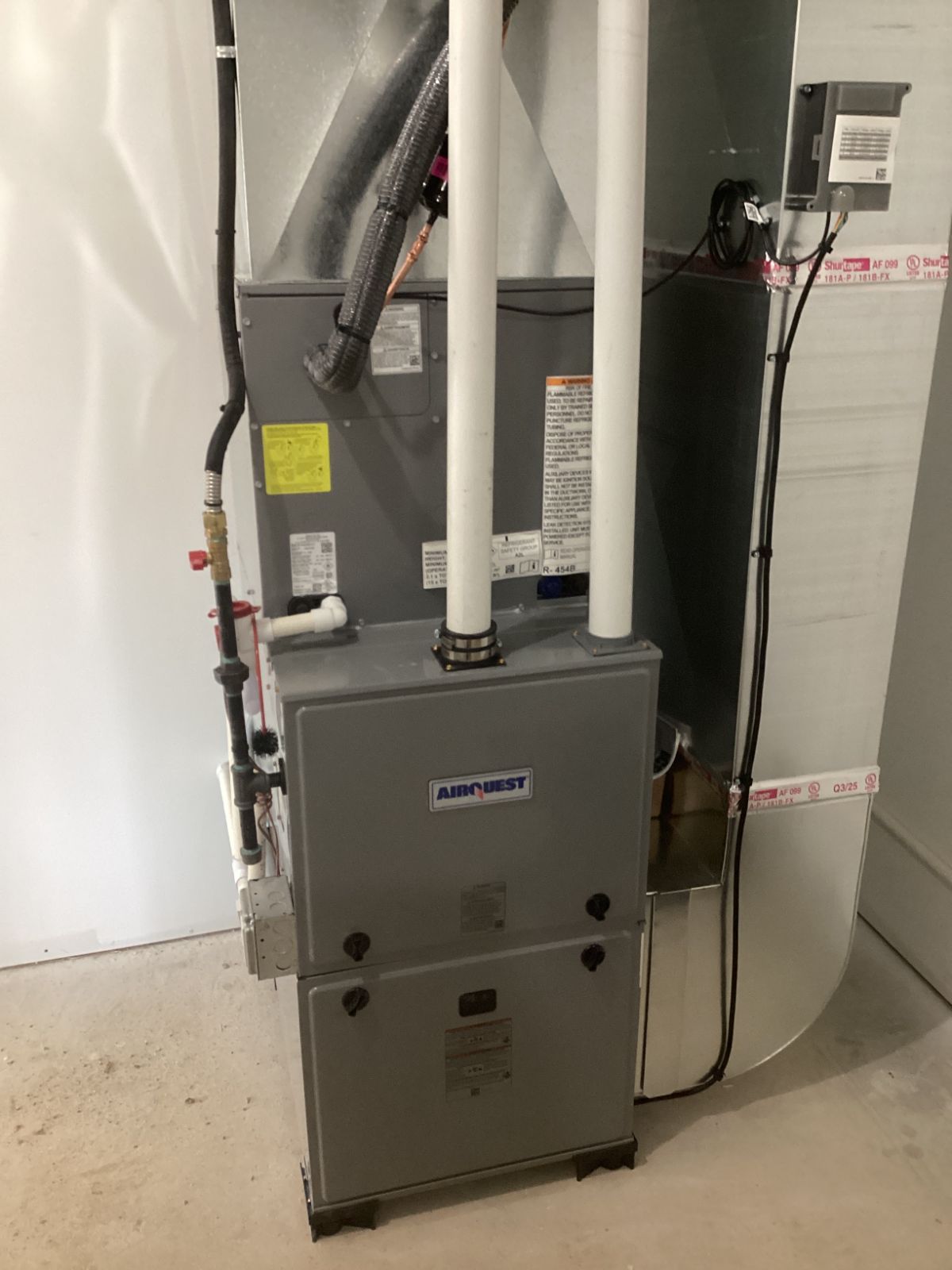 High-efficiency Airquest furnace in a home mechanical room